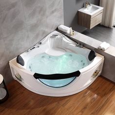 a large white bath tub sitting on top of a wooden floor