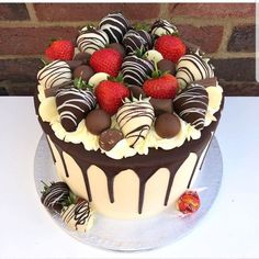 a chocolate covered cake with strawberries on top