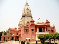 a large pink building with a flag on top