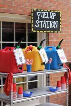 several plastic jugs are lined up on a metal shelf in front of a brick building