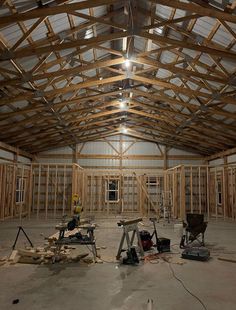 the inside of a building being built with wood framing and metal roof trussing on the ceiling