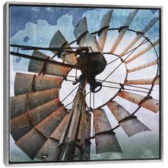 an old fashioned windmill with the sky in the background