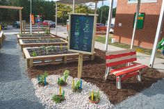 several wooden benches sitting next to each other in front of a building with plants growing out of them