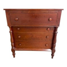 an old wooden dresser with three drawers on one side and two small knobs on the other