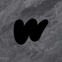 the letter w is made up of black letters on a gray marble background with dark spots