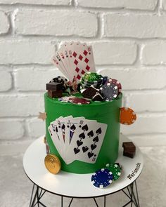 a cake made to look like a green bucket with playing cards and chips