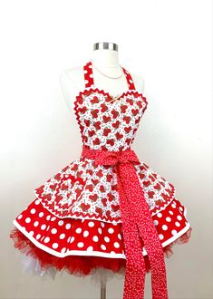 a red and white polka dot apron dress on a mannequin headdress