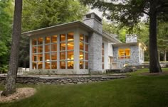 a modern house in the woods with large windows