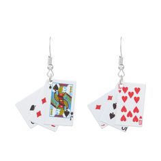 pair of playing cards dangling from silver earrings on white background, with clippings attached to them