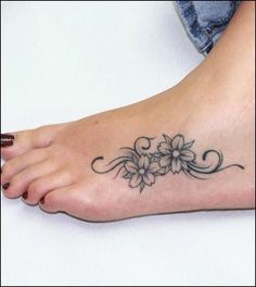 a woman's foot with a flower tattoo on the top and bottom of it