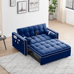 a blue couch sitting on top of a white rug