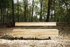 a wooden bench sitting in the middle of a forest