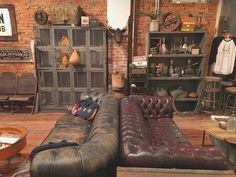 a living room filled with furniture and lots of clutter on top of wooden floors