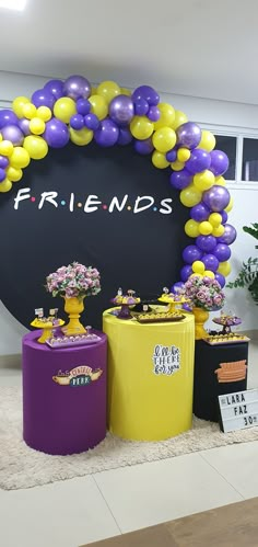 balloons and flowers are on display in front of a friends sign at the entrance to an event