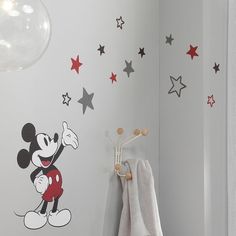 a mickey mouse wall decal in a child's room with stars on the walls