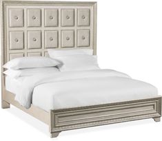 an upholstered bed with white linens and silver headboard, on a white background