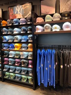 hats and shirts are on display in a hat rack at the true - fitted store