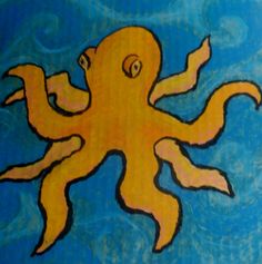 an orange octopus is floating in the blue water and has it's eyes open