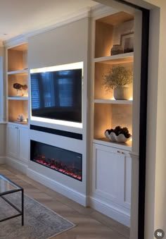 a living room with built - in fireplace and entertainment center