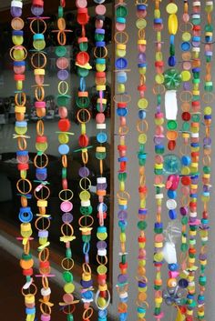 colorful beads hanging from the side of a building