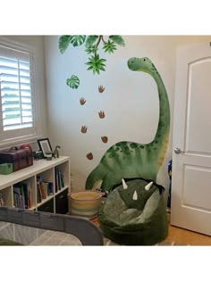 a child's bedroom with a dinosaur mural on the wall