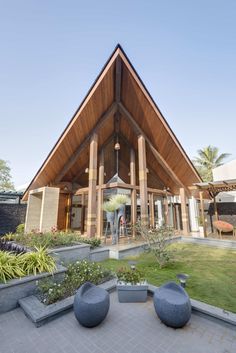 a large wooden building sitting on top of a lush green field