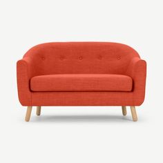 an orange couch with wooden legs and buttons on it's arm, against a white background