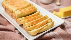 slices of bread on a white plate with butter