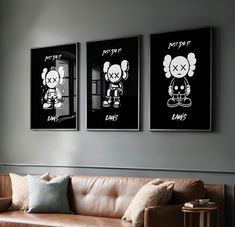 two black and white posters hang above a couch