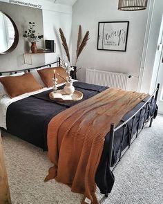 a bedroom with a bed, mirror and other items on the table in front of it