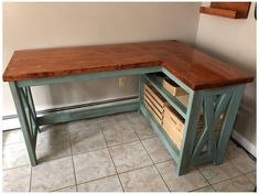 a wooden desk with drawers underneath it on tiled floor next to white wall and clock