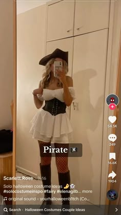 a woman in a pirate costume taking a selfie