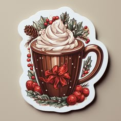 a sticker with a cup of hot chocolate and holly wreaths on the side