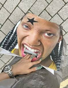 a woman with dreadlocks and a star painted on her face