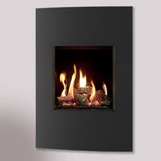 a fire burning inside of a black wall mounted fireplace