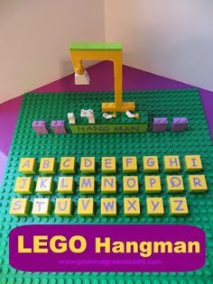 the lego hangman is sitting on top of the table with it's letters