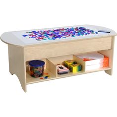 a child's wooden table with colorful paint on the top and drawers underneath it