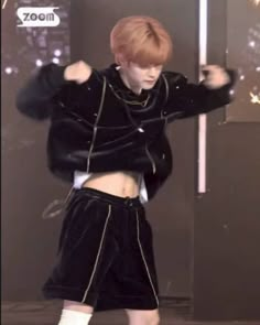 the boy is dancing in his black outfit