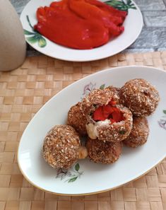 some food is on a white plate and next to a red sauce in a bowl