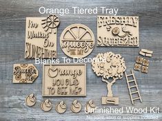 wooden cutouts with words and pictures on them, including an orange tree that says thanks to each member