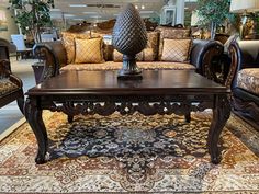 a living room filled with lots of furniture and pillows on top of a carpeted floor