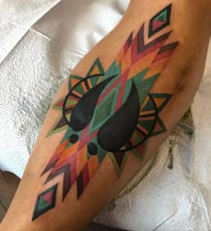 a colorful tattoo on the leg of a person