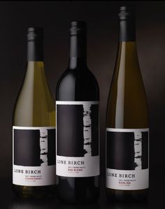 three bottles of wine sitting next to each other