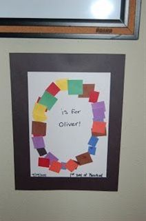 an art project is displayed on the wall above a framed photo with words that say it's for oliver