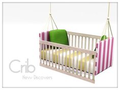 a baby crib with two pillows hanging from it's sides and a green pillow in the middle