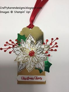 a christmas ornament hanging from a red ribbon