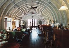 the inside of a large building with lots of furniture and decor on it's walls