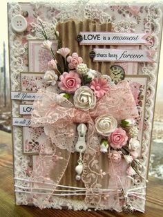 a close up of a card with flowers and ribbons on the front, along with words that read love is a moment