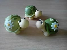 three little turtle figurines sitting on top of a table