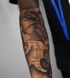 a man's arm with a map tattoo on it